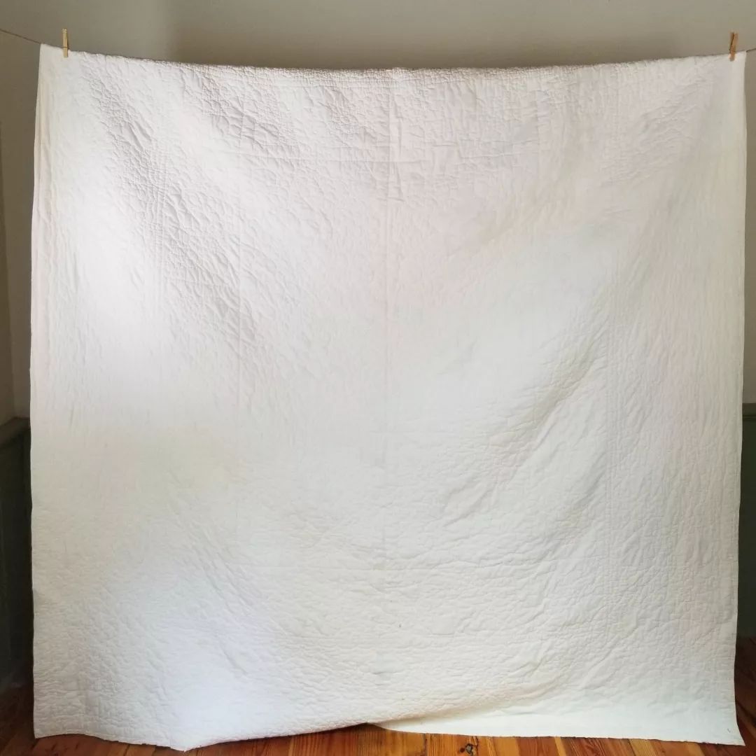 Blue and White Cross Stitched Quilt